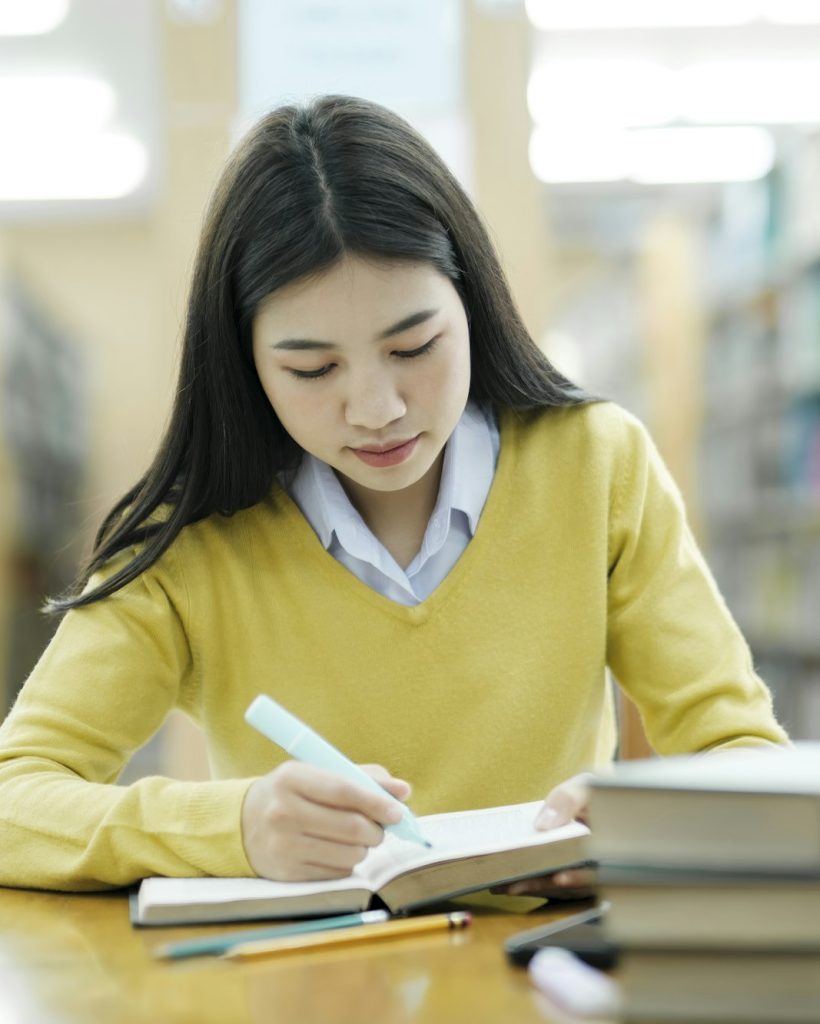 Student studying at library. Student studying at library.
